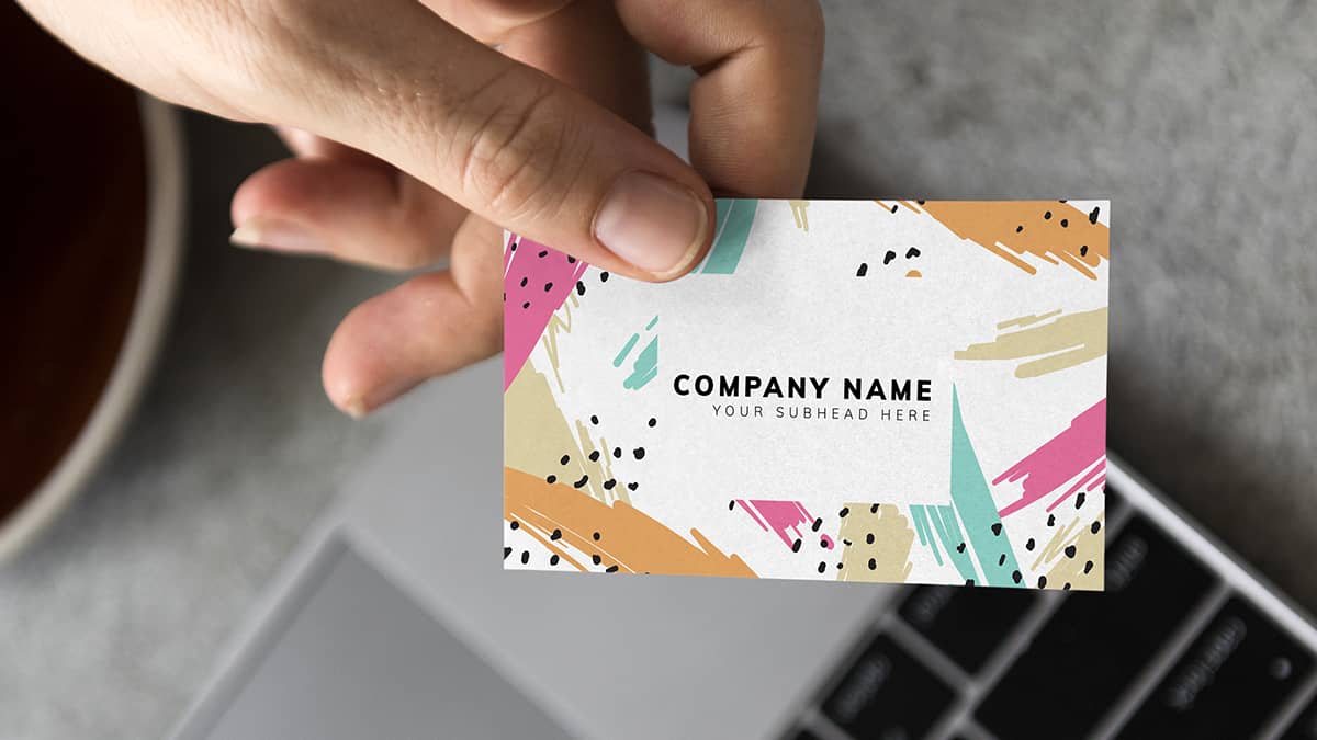 hand holding colorful business card out