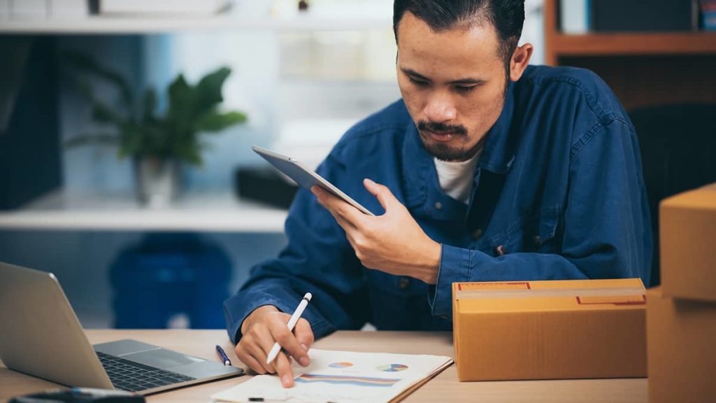 man working on accounting forms for his small business