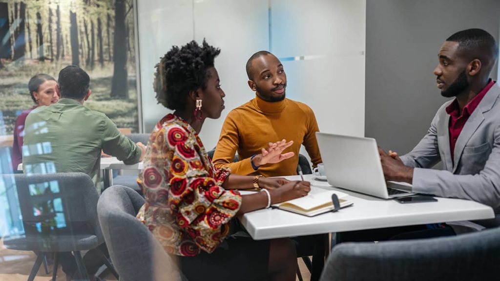 group of workers discussing finances in a meeting room