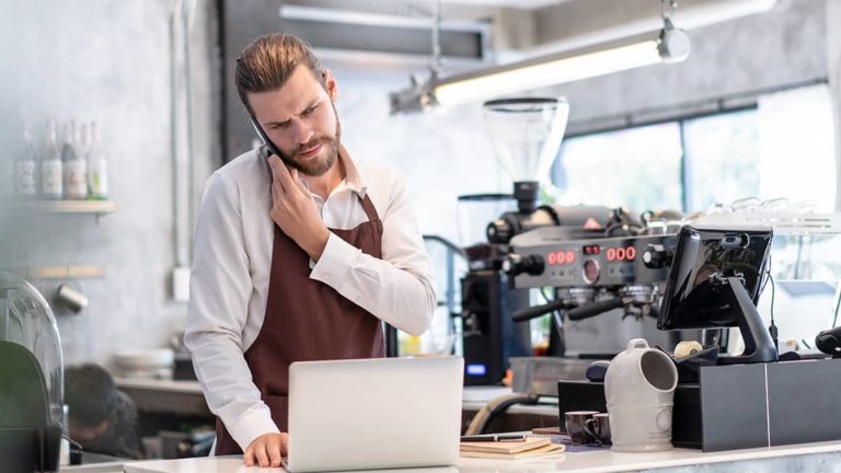 barista on the phone with a concerned look