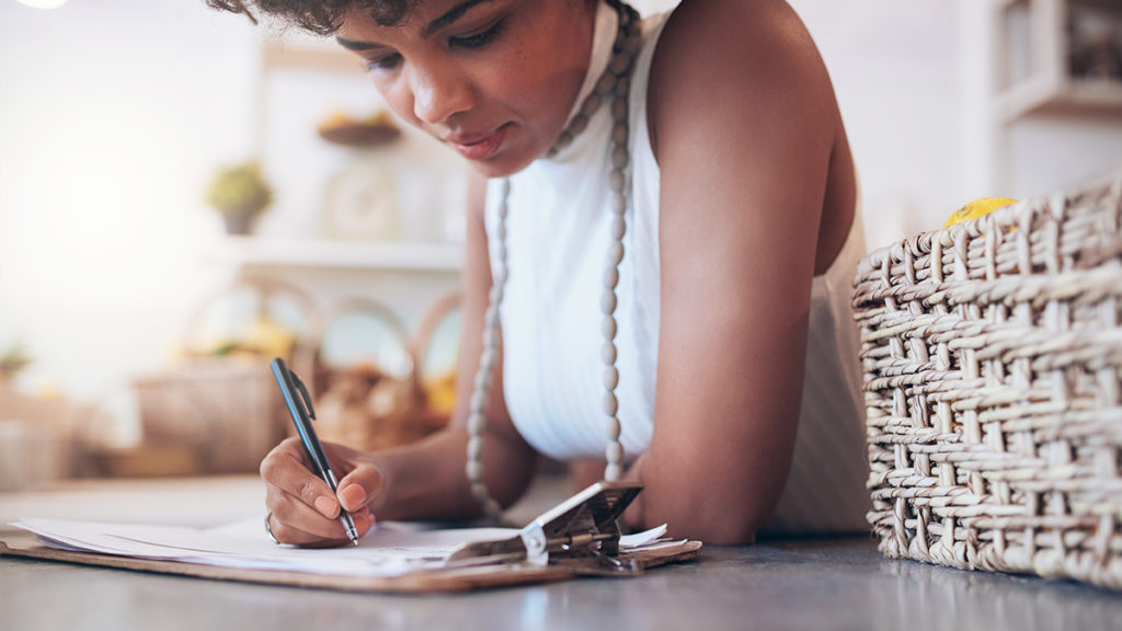 female business owner writing on a piece of paper