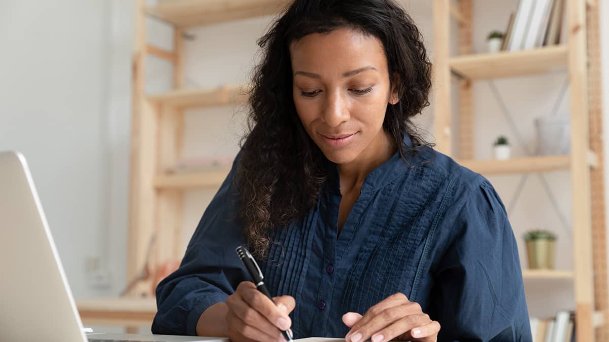 woman filling out a form at her desk