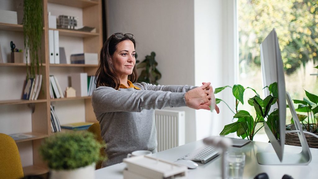 woman cracks her knuckles as she prepares to go on her computer